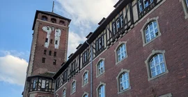 A large red-brick house with a tower.