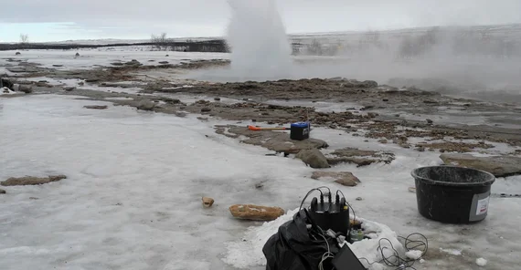 Eruption of Strokkur as seen from the west on 12 March 2020. It was recorded by the blueSeis-3A rotational sensor (black) and Trillium Compact seismometer (green) in the foreground. The pathway is open for tourist in summer but was icy and closed in winter. | Photo: Eva Eibl