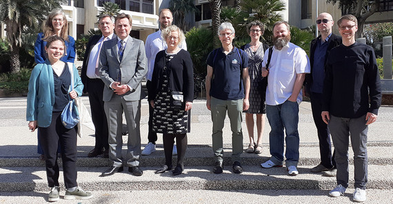 A group of people on the stairs in front of a builing.