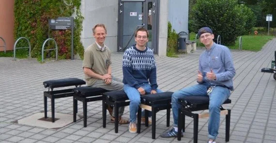 Detlef Pauligk (l.) testet mit den Studierenden die gemeinsam reparierten Klavierhocker.