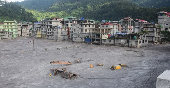Buildings and cars in the town of Rangpo were buried under the sediment masses of the flood.