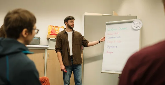 Julius Greiser next to a flip chart.