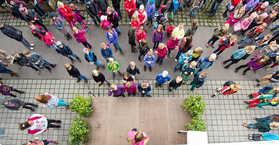 Kinder-Universität 2013. Kinder aus der Vogelperspektive vor einer Bühne.